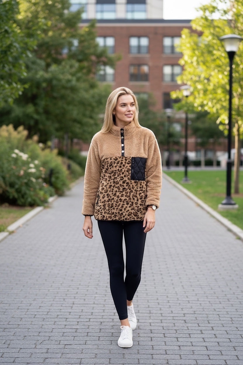 Restless beige sherpa fleece pullover with leopard print lower half, black quilted pocket, and snap-button collar.