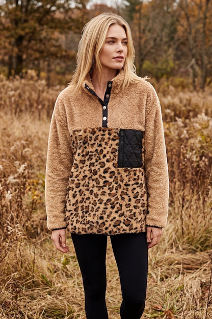 Restless beige sherpa fleece pullover with leopard print panel, black quilted pocket, and snap-button collar.