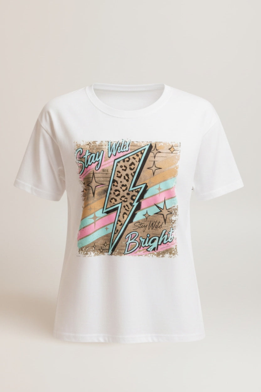 Restless white cotton t-shirt with a vibrant lightning bolt graphic featuring leopard print and pastel stripes. Text reads "Stay Wild Bright".
