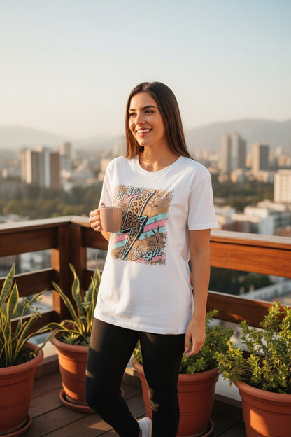 Restless white cotton t-shirt with a bold graphic featuring a lightning bolt, leopard print, and pastel stripes. Relaxed fit.